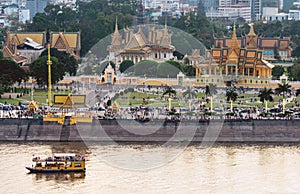 Phnom Penh river cruise boat passing the Royal Palace,at sunset,Cambodia