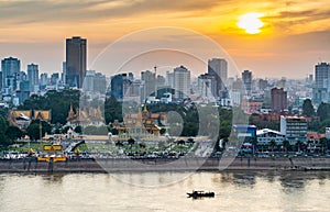 Phnom Penh river cruise boat passing the Royal Palace,at sunset,Cambodia