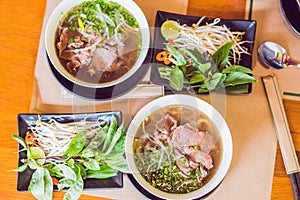 Pho Bo - Vietnamese fresh rice noodle soup with beef, herbs and