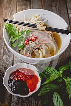 Pho Vietnamse Noodle Soup on Old Wood. Image for Food Advertise