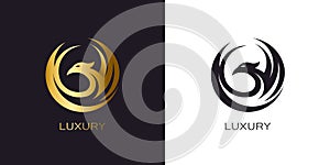 Phoenix Gold in circle logo stylized golden flying bird