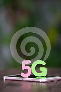 A phone and 5g alphanumeric model on the screen