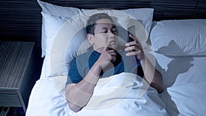 Phone Addicted, Man Using Smart Phone on Bed at Midnight