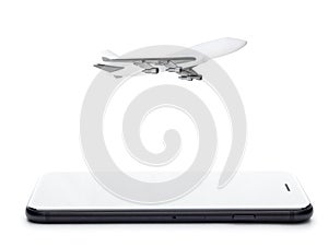 Phone and airplane model on white