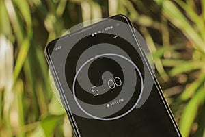 A phone with a black and white five-minute timer