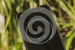 A phone with a black and white four-minute timer