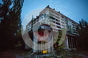 Phone box and abandoned buildings of ghost town Pripyat Chornobyl Zone photo