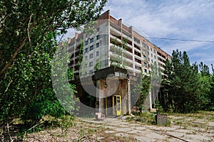 Phone box near abandoned building in centre of ghost town Pripyat Chornobyl Zone photo