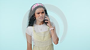 Phone call, angry woman and scam with conversation and problem in a studio. Blue background, female person and mobile