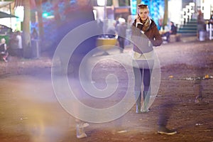 Phone call, blur and woman in city at night, communication or listening to conversation. Smartphone, chat and person