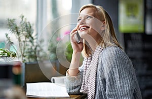 Phone call, coffee shop and woman with smile for conversation, social networking and talking. Restaurant, cafe and happy