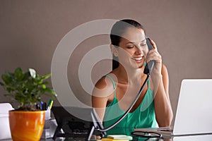 Phone call, remote work and landline with woman secretary in office for communication or reception. Laptop, smile and