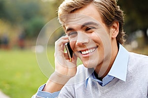 Phone call, student and man with smile, park and nature to relax in university, talking and listening to contact