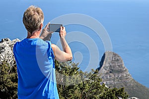 Phone cameras for holiday snapshots by female tourist