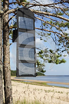 Phone charges via USB cable from the portable foldable solar panel