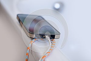 phone charging on edge of bathtub, Charging Devices Caution, Preventing Water-Related Accidents, Home Safety Concerns