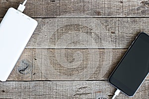 Phone charging with power bank on wood