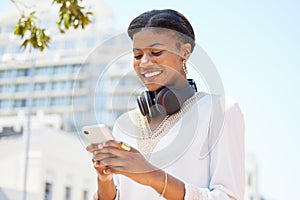 Phone, city and music with a business black woman typing a text message while walking to work outdoor. Mobile