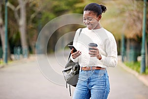 Phone, coffee and mockup with a student black woman on her commute to university campus for education. Mobile, social