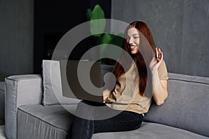 Phone conversation. Confident young woman sit on couch talk speak communicate by telephone from home holding device at ear. Teen