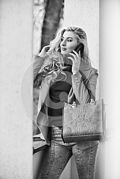 phone conversation. Fashion fall portrait of trendy woman. posing on the street. Fashion photo of young stylish woman