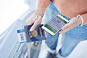 Phone, covid passport and qr code in the hands of a woman passenger in the airport for immigration, travel or control