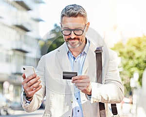 Phone, credit card and businessman travel using online payment for a commute mobile app, online and on the internet