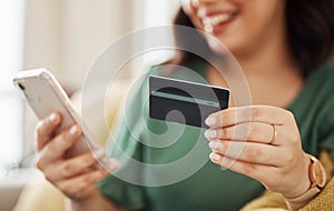 Phone, credit card closeup and woman hands with online shopping and banking at home. Ecommerce, mobile cashback and sale