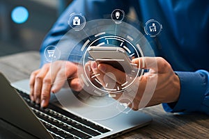 Phone displaying a digital interface, laptop in the background