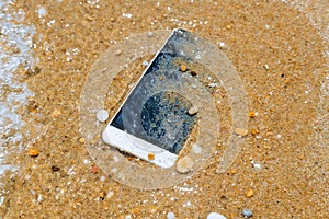 Phone dropped into the water of sea background