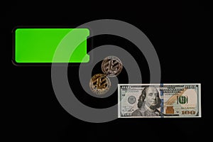 Phone with green screen, dollar bill and litcoin coins isolated on black background