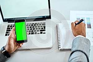 Phone, green screen and man hands writing notes, ideas and laptop planning for mobile app mockup and business website