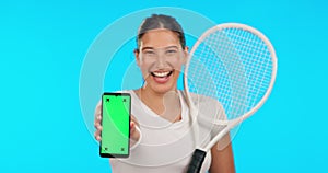 Phone, green screen and a woman tennis player on a blue background in studio for sports marketing. Portrait, smile and