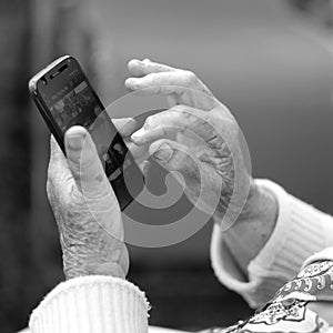 Phone in the hands of an elderly woman