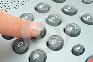 Phone keypad and woman finger