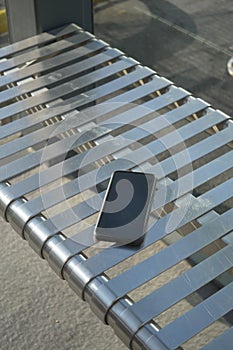 Phone left on a public bench.lost smart phone concept