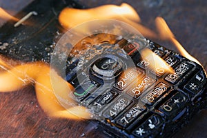 the phone lies on the table and burns with a bright flame