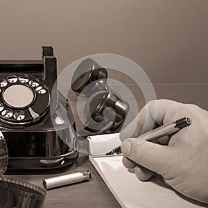 Phone message. The hand writes the text. Retro, black and white. square format