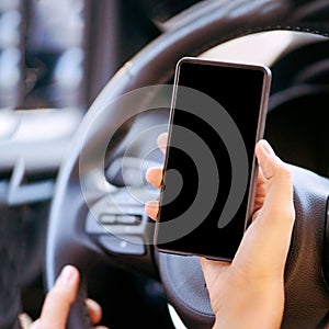 Phone mockup inside car. Travel driver seach maps. Empty screen. Vehicle navigation location. Hand holding mobile