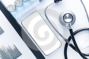 Phone mockup. Medical equipment: doctor stethoscope, hospital healthcare charts, syringe with needle and black smartphone with