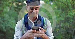 Phone, nature and man hiking in woods networking on social media, mobile app or internet. Smile, technology and male