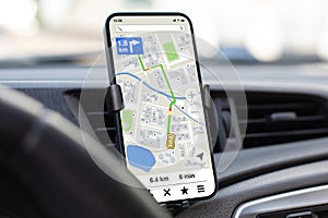 phone with navigation application background of steering wheel in car