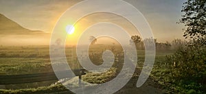 Beautiful scenic sunrise landscape with some fog in background