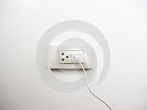 Phone plugged in on socket wall, charging