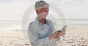 Phone, relax and senior woman at beach for text message, social media and communication. Contact, summer and travel with