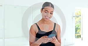 Phone, social media and communication with a woman dancer typing a text message in a dance studio. Mobile, internet and