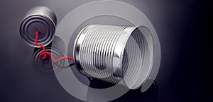 Phone toy from a tin can lying on a smooth black polished table