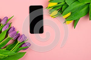 Phone and tulips on pink background