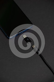 Phone with USB Type C and Micro USB to Type C adapter and cable.