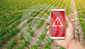 The phone warns of the danger on the sweet pepper plantation farm field. Monitoring and analysis of presence of chemicals, heavy